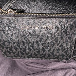 Micheal Kors wallet with multiple inside and outside slots.